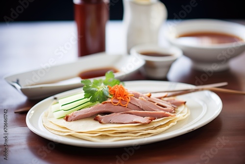 peking duck slices with pancakes and hoisin sauce photo
