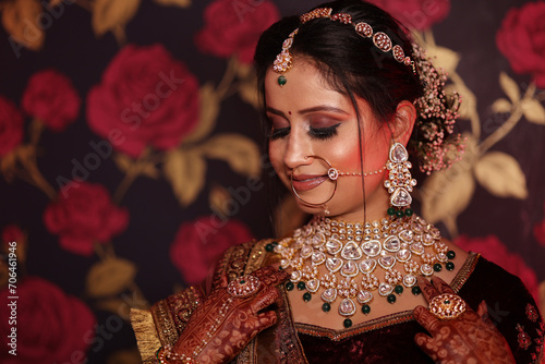 Portrait of beautiful indian bride wearing kundan jewellery at her wedding event, photo