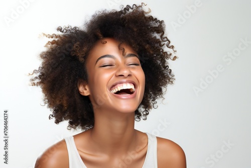 professional portrait studio photo of a handsome young afro american tatooed woman model with perfect clean teeth laughing and smiling. isolated on white background. for ads and web design 