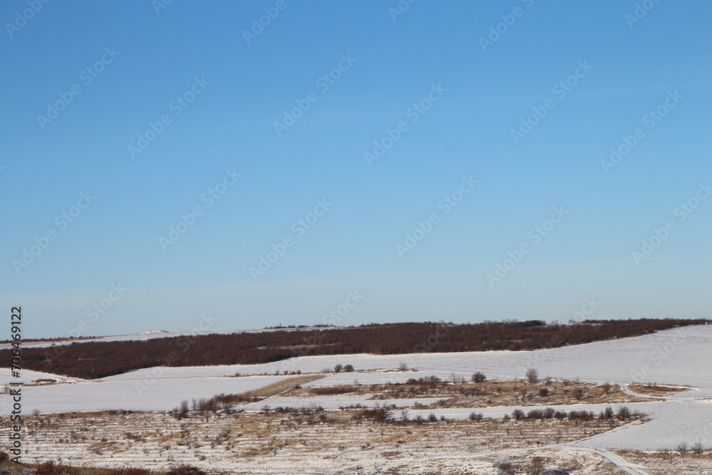 A field with snow and a blue sky
