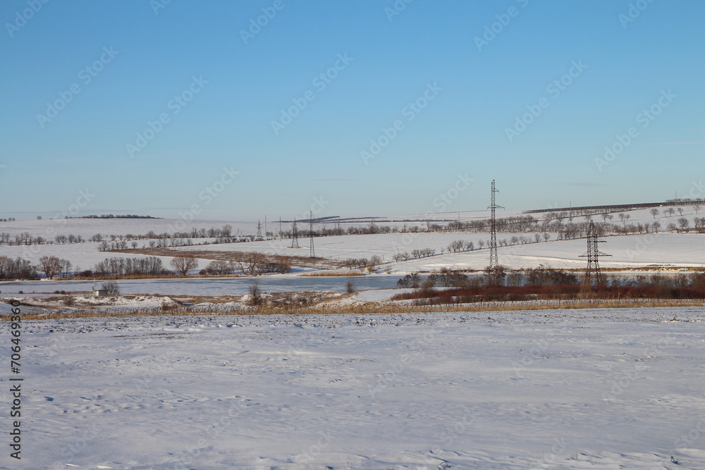 A snowy landscape with power lines