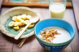 gluten-free granola bowl with soy milk and banana coins
