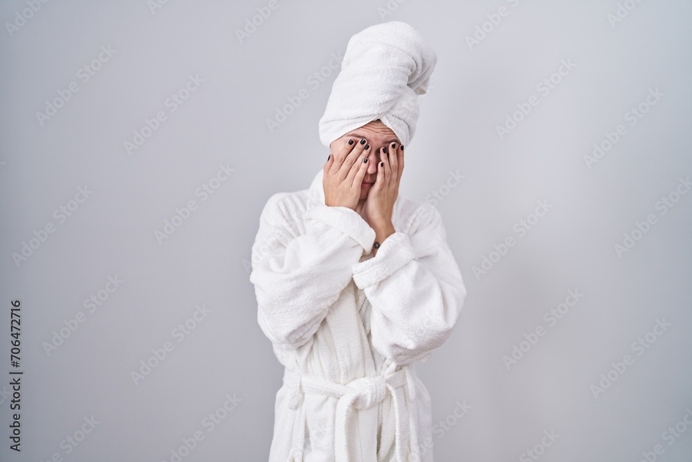 Blonde caucasian woman wearing bathrobe rubbing eyes for fatigue and headache, sleepy and tired expression. vision problem