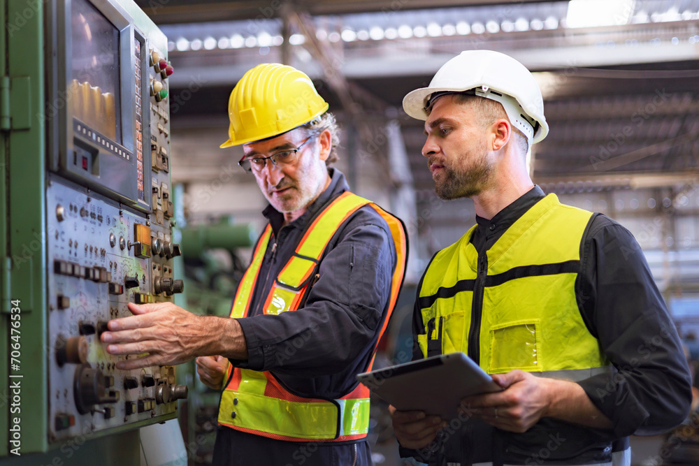 two engineer look projects and planning with tablet mobile in factory two engineer look projects and planning with tablet mobile in factory