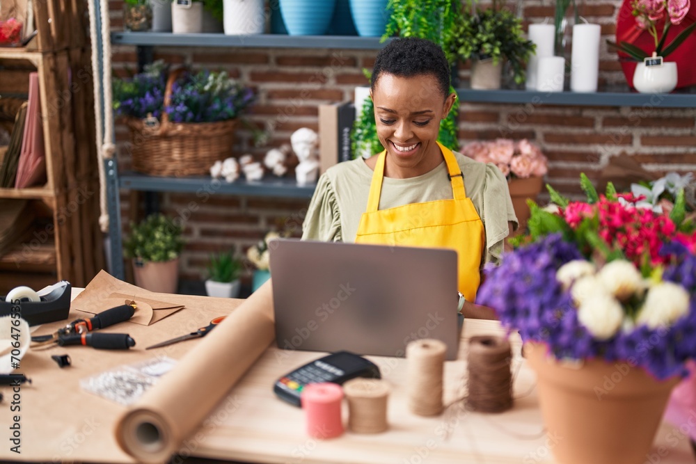 African american woman florist smiling confident using laptop at florist African american woman florist smiling confident using laptop at florist