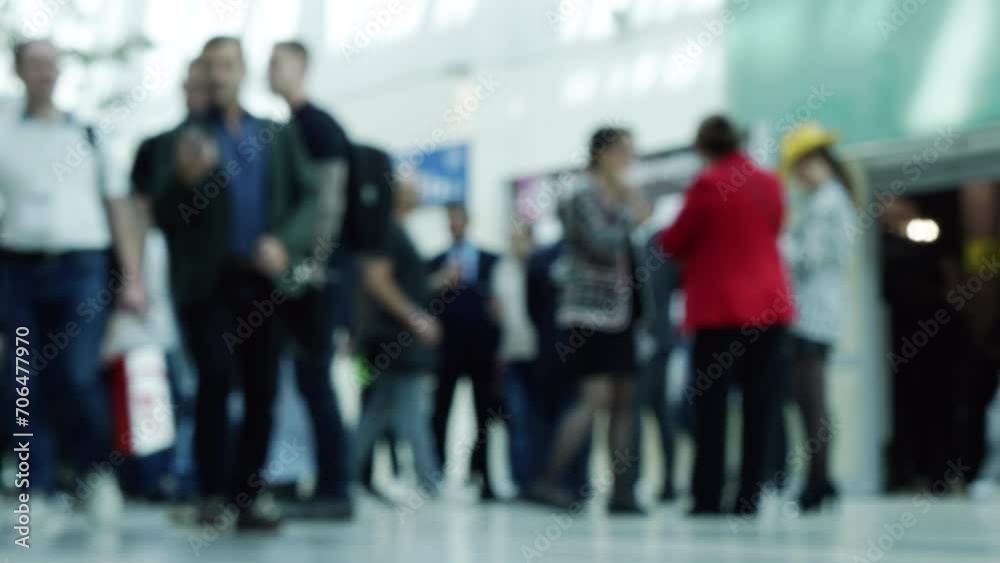 The movements of many business people passing through the business center.