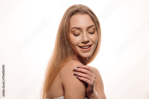 Beauty portrait of a pretty blonde girl posing on an isolated white background. Skin care concept