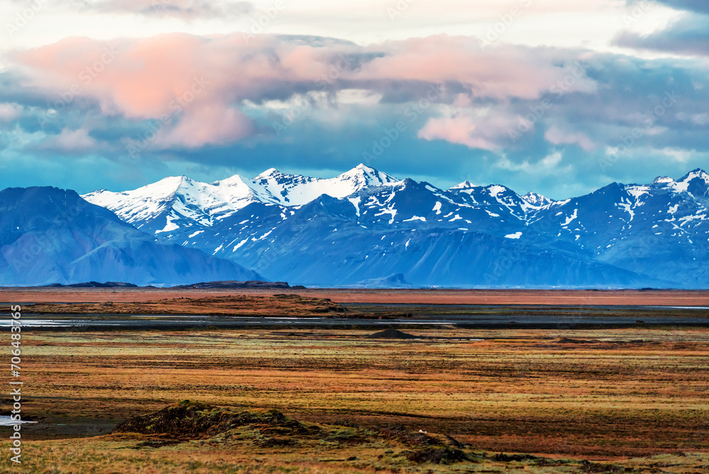 Landscape with snowy mountains and desert in Iceland at sunset Landscape with snowy mountains and desert in Iceland at sunset