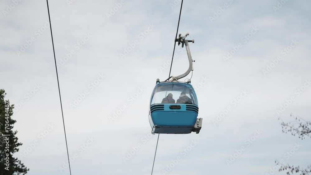Gondola cabin lift in the ski resort over the high mountains on the blue sky background in sunny day with copy space, slow motion Gondola cabin lift in the ski resort over the high mountains on the blue sky background in sunny day with copy space, slow motion