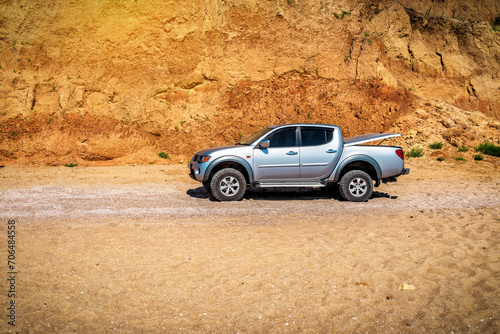 Silver off road car on the sand of desert beach