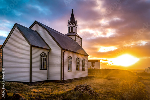 Typical rural Icelandic Church at sea coastline on sunset