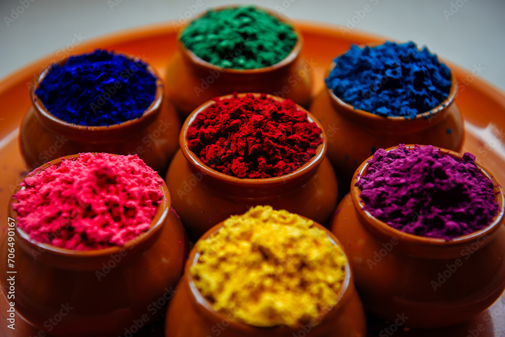 Various Holi paints in pots on a tray. Colorful background for the national Indian holiday Happy Holi