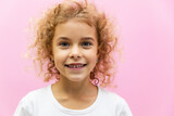 Close-up portrait of her she nice-looking attractive lovely healthy glad cheerful curly hair girl enjoying good mood idea solution on pink pastel color background. Advertising for children's products
