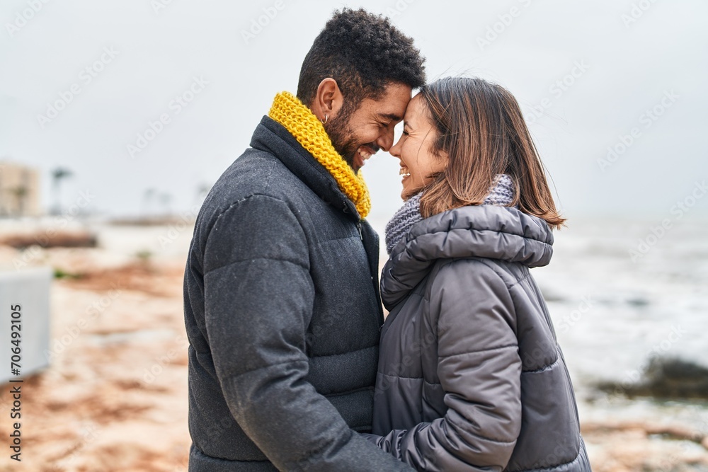 Man and woman couple smiling confident hugging each other at seaside Man and woman couple smiling confident hugging each other at seaside