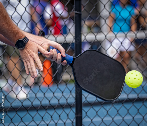 Extreme close up of pickelball paddle and ball