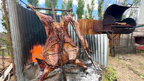 Patagonian Culinary Delight: Spit-Roasted Lambs Amidst Flames on a Beautiful Evening