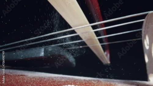 Concert of the symphony orchestra close-up of the bow on the violin, the concept of the development of musical taste classical music playing stringed classical musical instruments photo