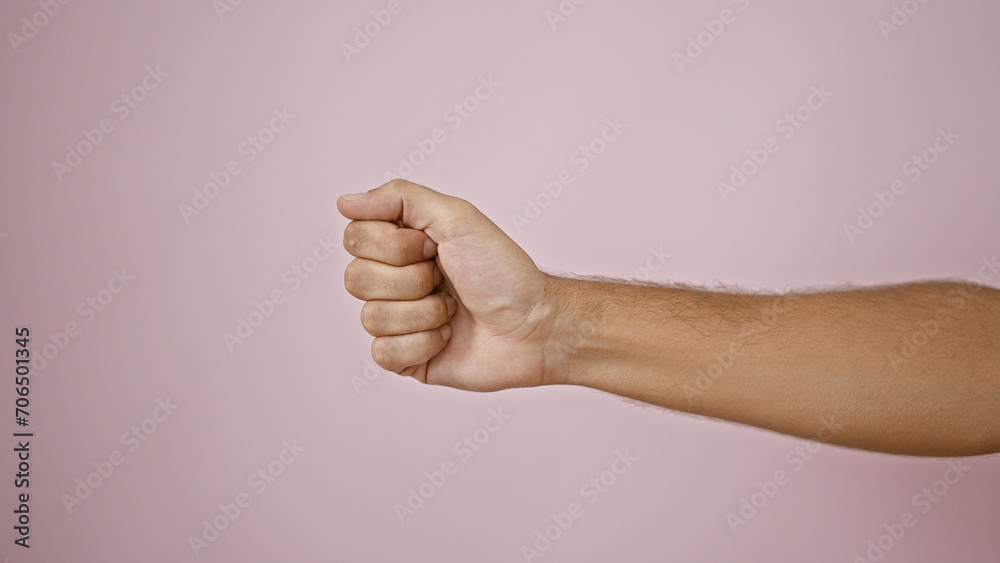 Close-up of a male fist against a pink isolated background, conveying strength or solidarity. Close-up of a male fist against a pink isolated background, conveying strength or solidarity.