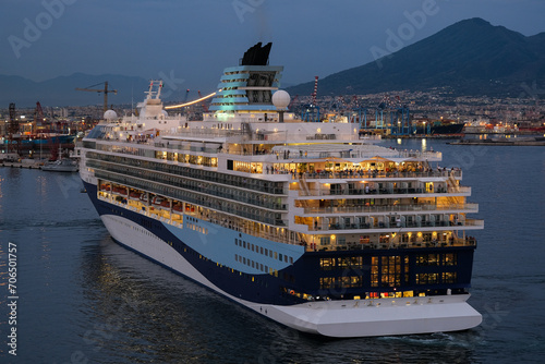 Marella cruiseship cruise ship liner Explorer 2 sail away departure from port of Naples, Italy with Vesuv volcano in background during sunset twilight hour photo