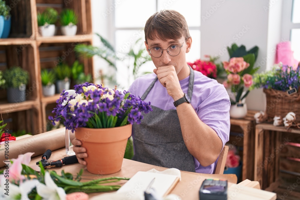 Caucasian blond man working at florist shop feeling unwell and coughing as symptom for cold or bronchitis. health care concept. Caucasian blond man working at florist shop feeling unwell and coughing as symptom for cold or bronchitis. health care concept.