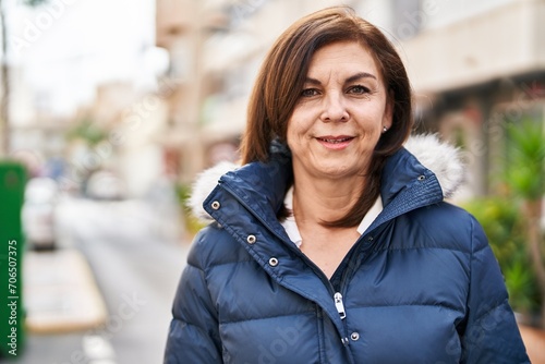 Middle age woman smiling confident standing at street
