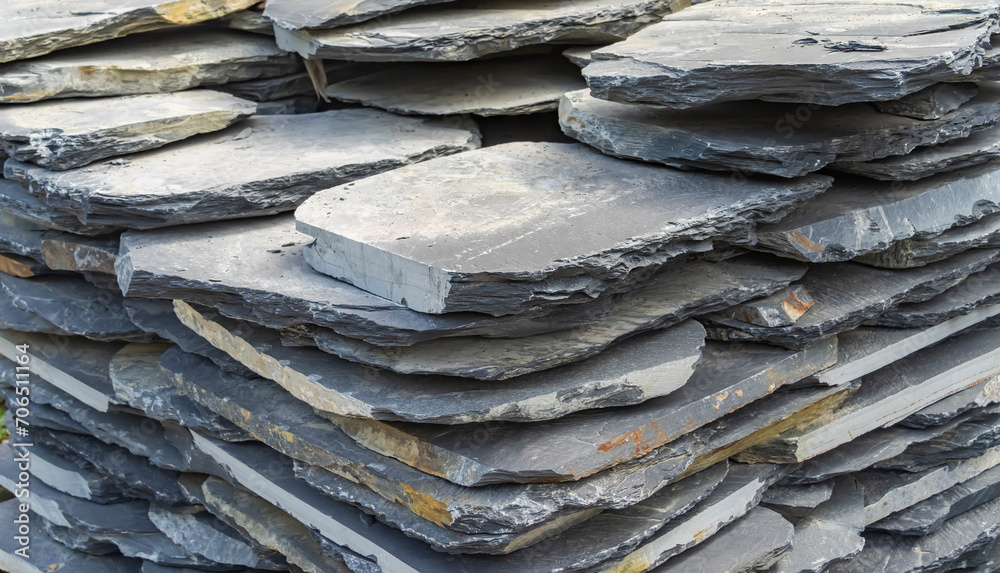 Stack flat slate stones cladding of wall used for flooring, walkways or wall decoration.Background texture Stack flat slate stones cladding of wall used for flooring, walkways or wall decoration.Background texture