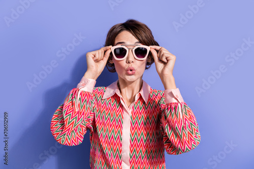 Portrait of funny astonished girl wear shirt fingers touch stylish sunglass staring at promo plump lips isolated on blue color background