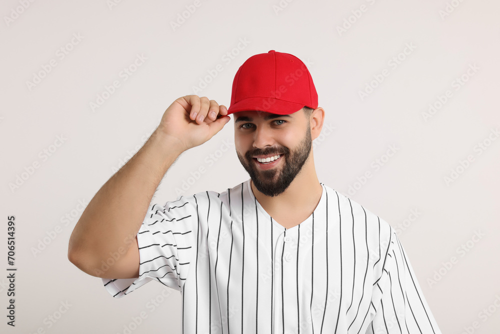 Man in stylish red baseball cap on white background
