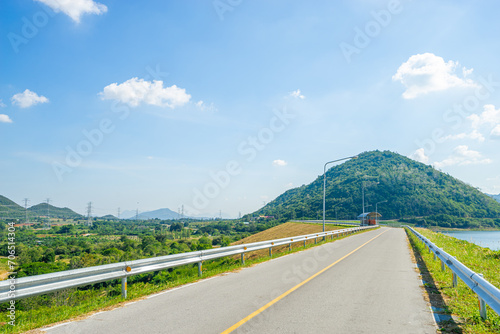 Beautiful scenic of the road in dam ridge with green grass at water dam.