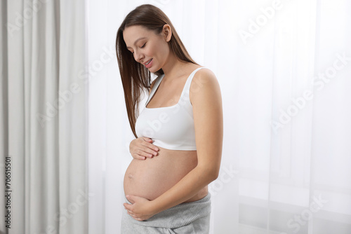Beautiful pregnant woman with long hair near window indoors Free Download Beautiful pregnant woman with long hair near window indoors - GFXLoad
