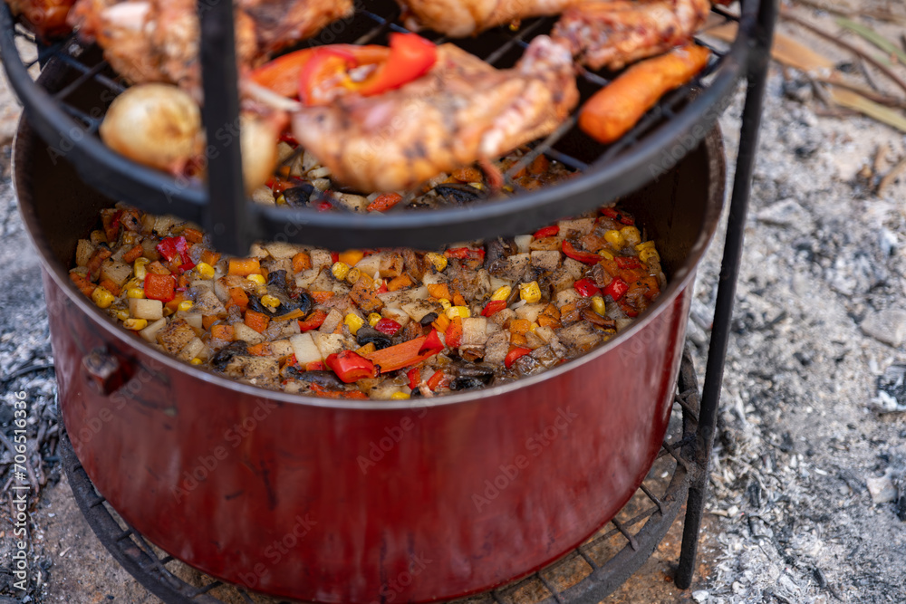 Zurbian dinner. The barrel has been uncovered and it is ready and well cooked. It contains chicken, vegetables and rice. It is placed on a wire rack and it has been transferred to the serving tray. - obrazy, fototapety, plakaty 