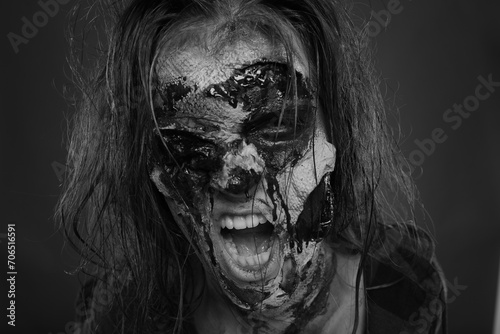 Scary zombie on dark background, black and white effect. Halloween monster