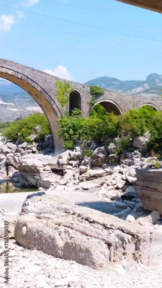 Aerial view of the Old Mes bridge near Shkoder from above. Albania, Europe. Ottoman stone arch bridge Ura e Kadiut Aerial view of the Old Mes bridge near Shkoder from above. Albania, Europe. Ottoman stone arch bridge Ura e Kadiut