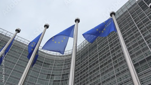 EU flags waving in front of European Commission building in Brussels, Belgium photo
