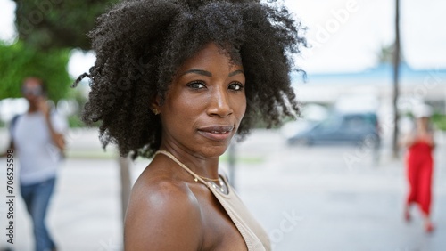 African american woman standing with serious expression at street © Krakenimages.com