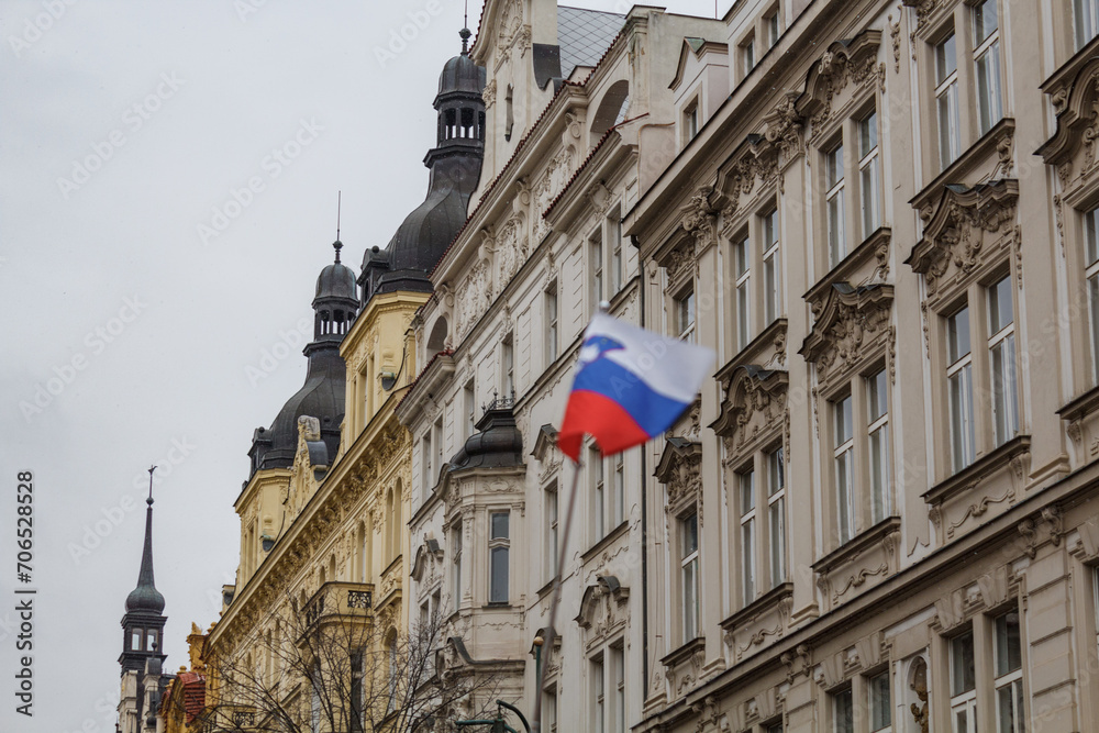 A slovenian flag in front of a historic building in Prague city on a freezing cold december day