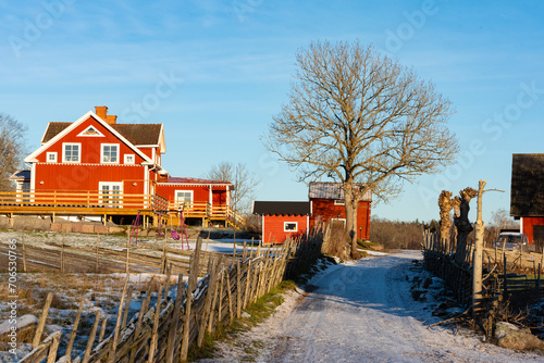Typical red wooden house in Sweden in winter in the Bråbyggden area in eastern Småland. The photo was taken on a sunny winter day at Christmas time