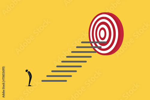 Businessman looking up stair to reach goal. concept of Reach target or reach goal, success, achievement or growth, challenge and motivation