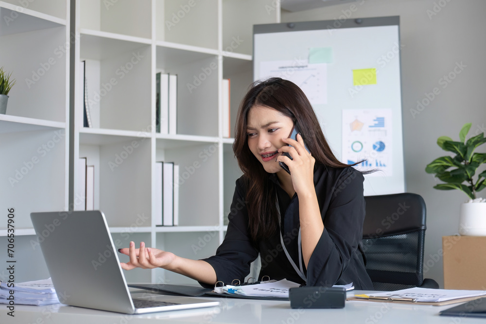 Happy asian business woman have the joy of talking on the smartphone, tablet and laptop on the modern office