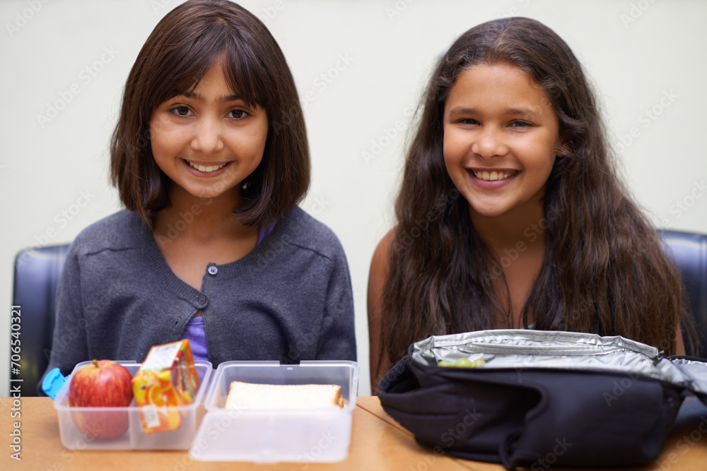 Girl, friends and portrait with lunch at school for recess, break or nutrition at table and happy. Kids, face and smile at academy or relax with confidence, food or pride for childhood development Girl, friends and portrait with lunch at school for recess, break or nutrition at table and happy. Kids, face and smile at academy or relax with confidence, food or pride for childhood development