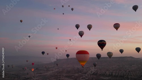 Hot air balloon flight in Goreme in Turkey during sunrise. Ride in a hot air balloon, the most popular activity in Cappadocia. Romantic and famous travel destination. photo