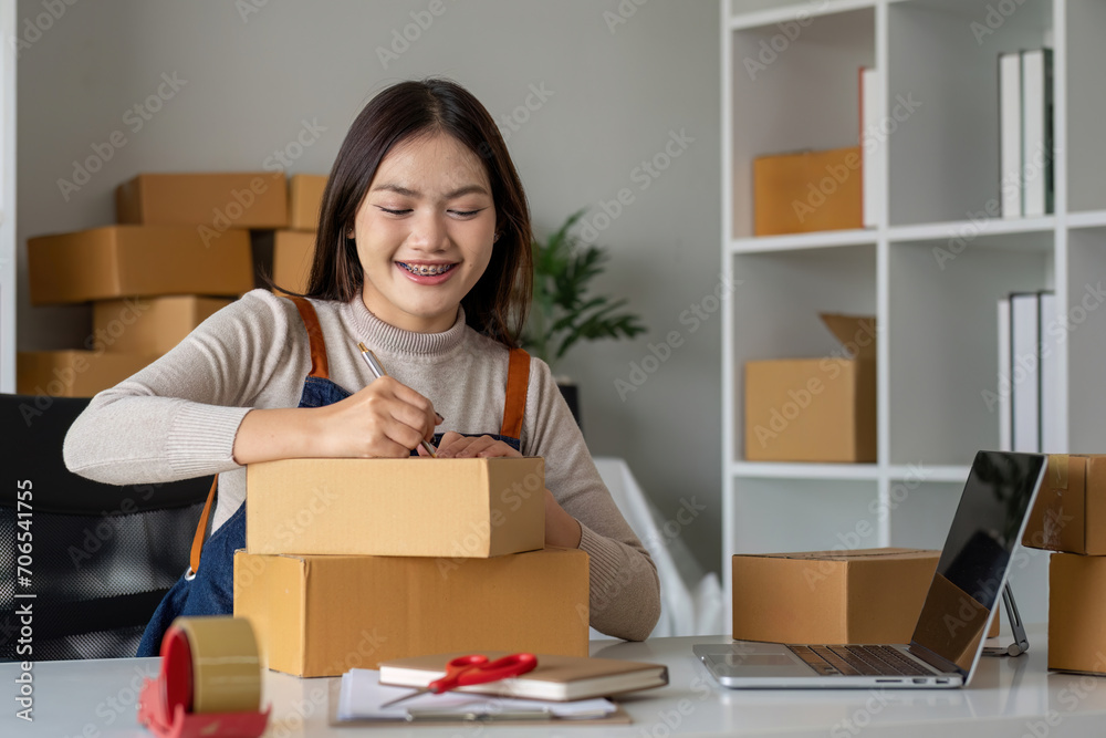 SME entrepreneur small business online sales concept, happy Asian business owner working on computer and boxes at home, SME Procurement parcel delivery box sending to customer, SME entrepreneur small business online sales concept, happy Asian business owner working on computer and boxes at home, SME Procurement parcel delivery box sending to customer,