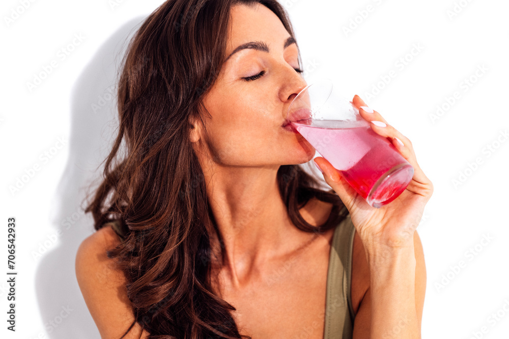 Young caucasian woman holding glass of water with collagen Young caucasian woman holding glass of water with collagen