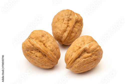 Three whole walnuts on white