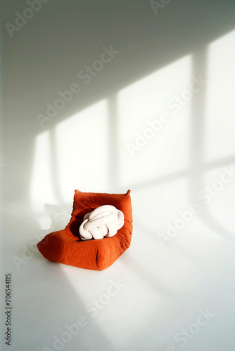 orange bean bag chair in a photo studio