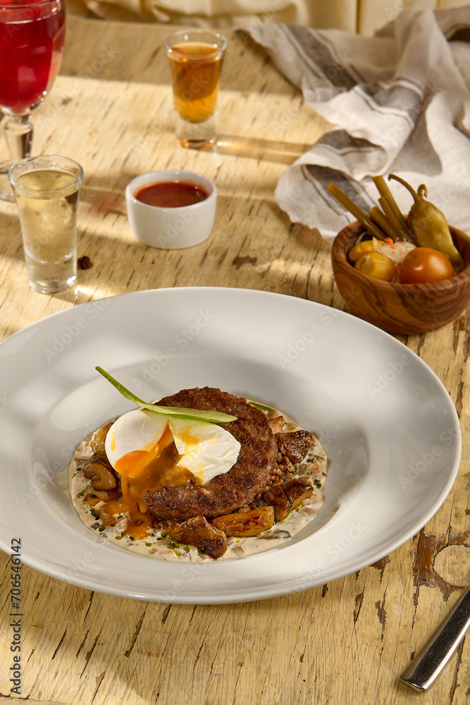 Beefsteak with an egg and white mushrooms, a rich and savory dish Beefsteak with an egg and white mushrooms, a rich and savory dish