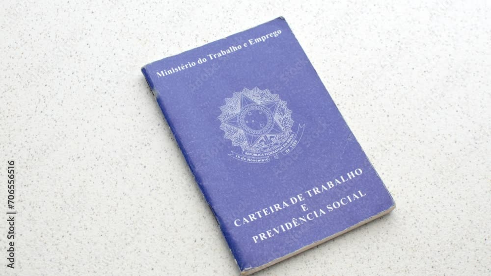 Brazilian Work ID. Unemployment, job, or salary increase. On a clear surface: Employment symbols reflected on the ID, depicting the pursuit of opportunities, laid on an illuminated table. Brazilian Work ID. Unemployment, job, or salary increase. On a clear surface: Employment symbols reflected on the ID, depicting the pursuit of opportunities, laid on an illuminated table.