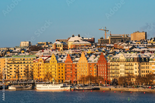 The southern side of Kungsholmen island in Stockholm, with the historic colorful buildings in the soft winter sunshine, snow on the roof and winter conditions. Clear sky. photo