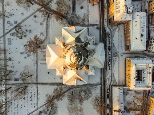 Photography Vertical aerial view of the roof of a church in Stockholm, Sweden, with snow and the first morning sun light