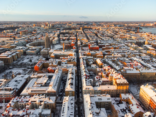 Aerial panoramic view of the district of Sodermalm in Stockholm, Sweden, in winter with snow on the roofs and morning sun.